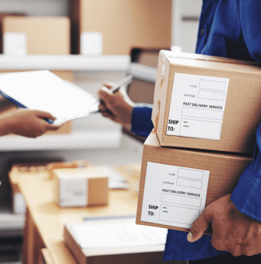 Courier with parcels signing document in delivery service office